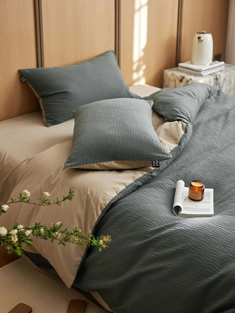 Close-up of the Slate Grey Wavy Textured pillow sham and duvet cover on a beige sheet. - RoomDen