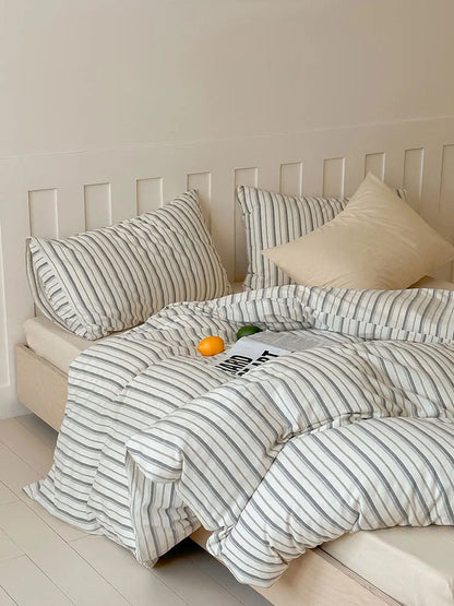 Lifestyle image of the Grey Pinstripe Washed Cotton Bedding Set, looking cozy and inviting. - RoomDen