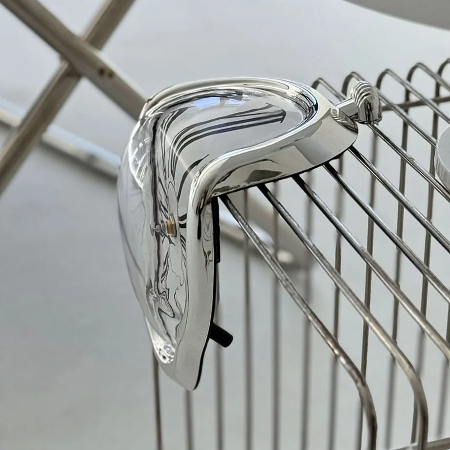 Side profile of the silver melting clock showing how it hangs over an edge.