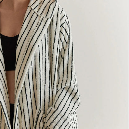 Front detail view of the open robe showing the plush texture and black undergarment contrast.