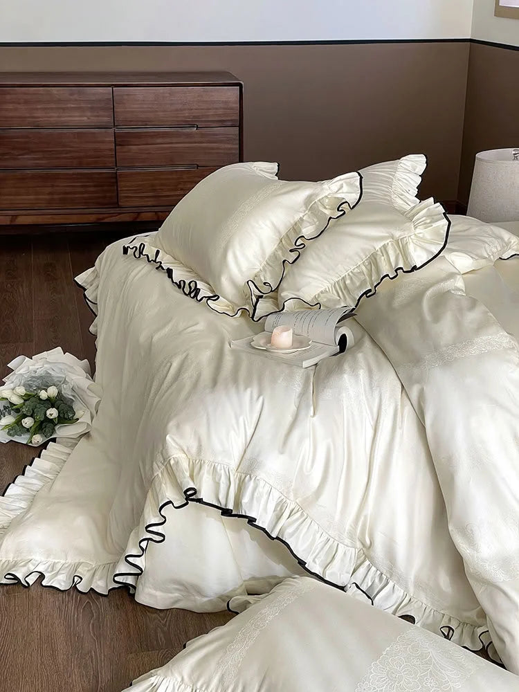 Lifestyle shot showing the Cream White ruffled Tencel duvet cover draped over the bed in a cozy bedroom setting - RoomDen.