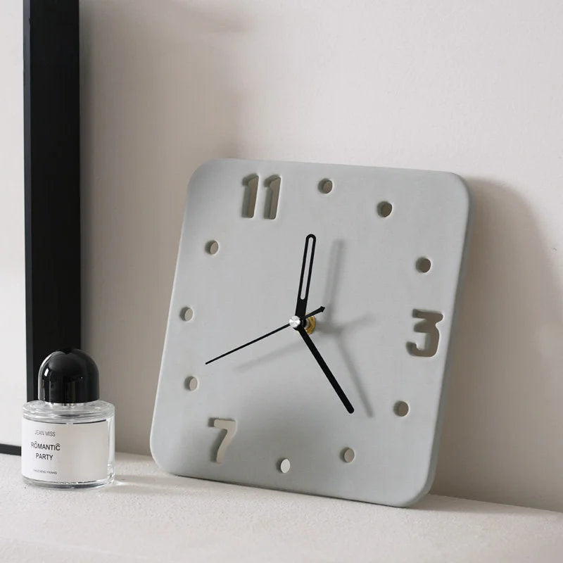 Light Grey Minimalist Cutout Ceramic Table Clock on a desk with perfume bottle - RoomDen.