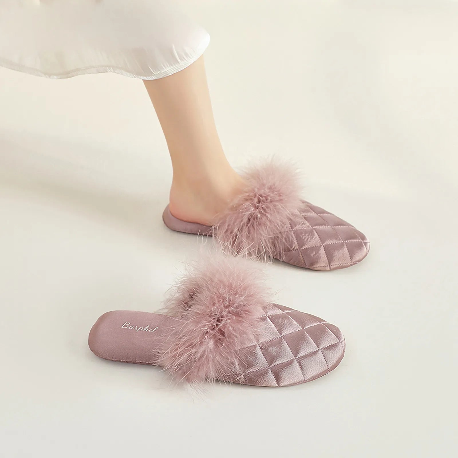 Mauve purple quilted satin slides with plush fur detail on legs