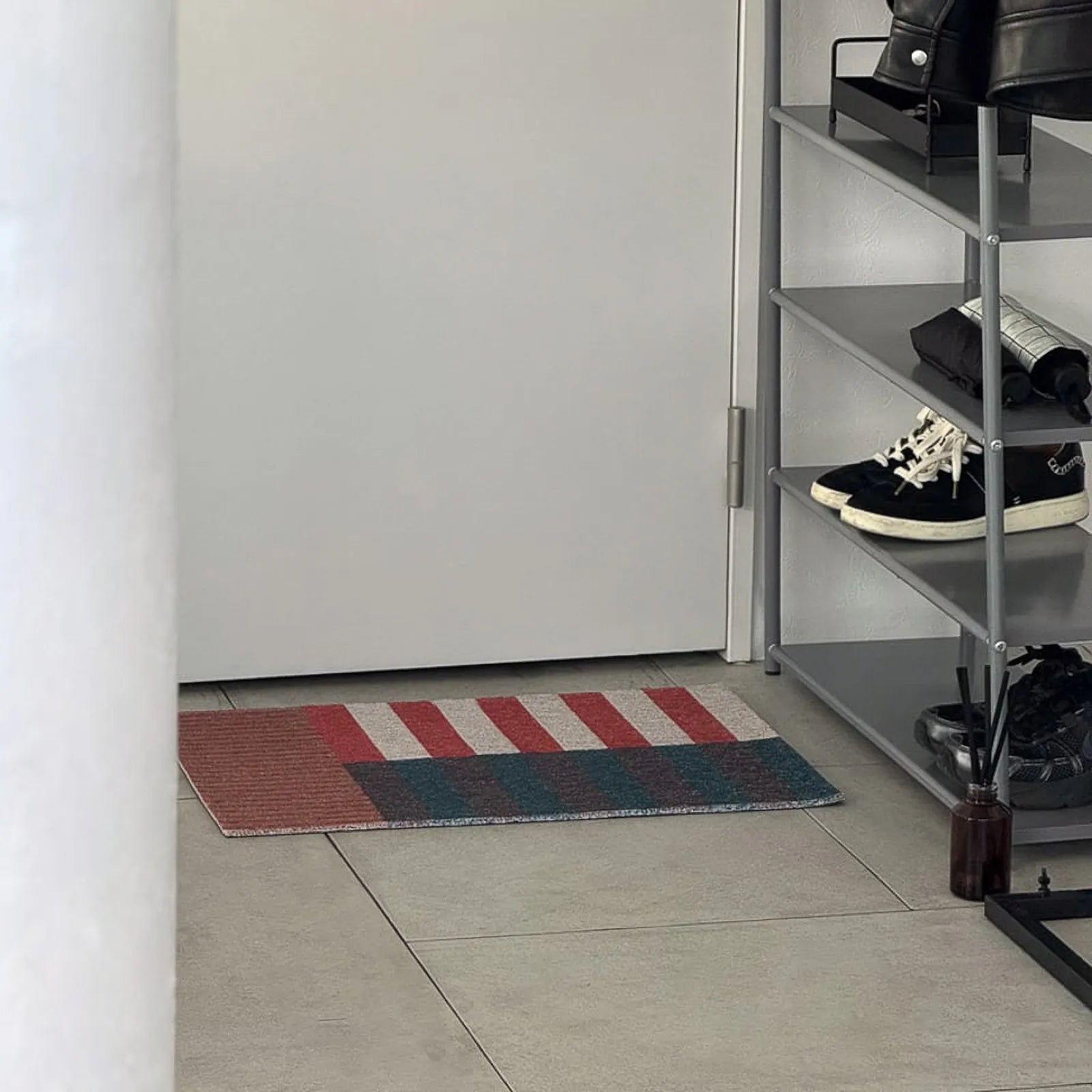 Grey tiled floor with non-slip PVC doormat in geometric pattern - RoomDen
