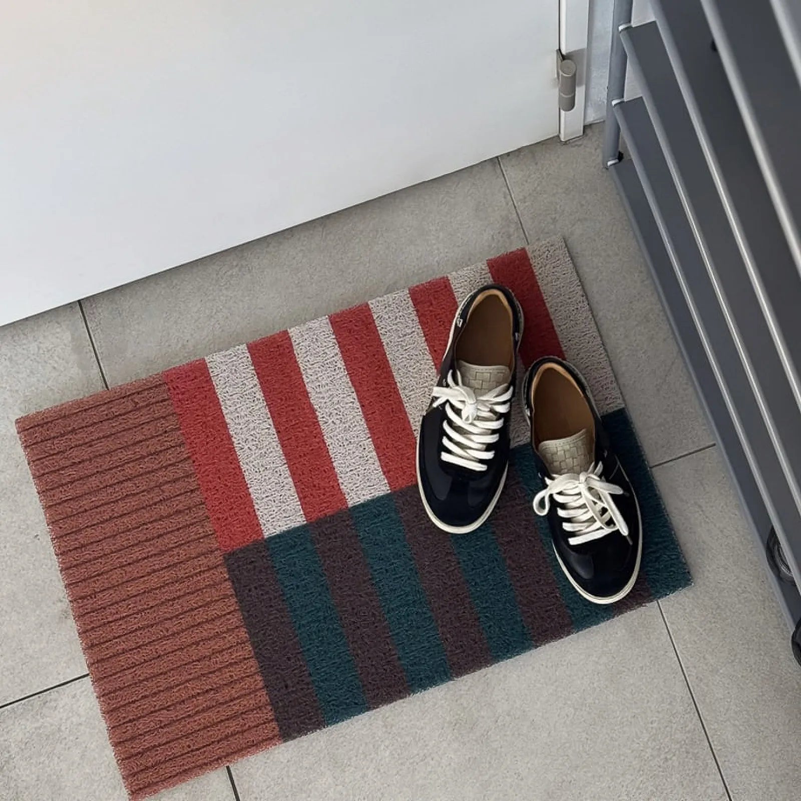 Sneakers placed on the rust and green stripe wire loop mat - RoomDen
