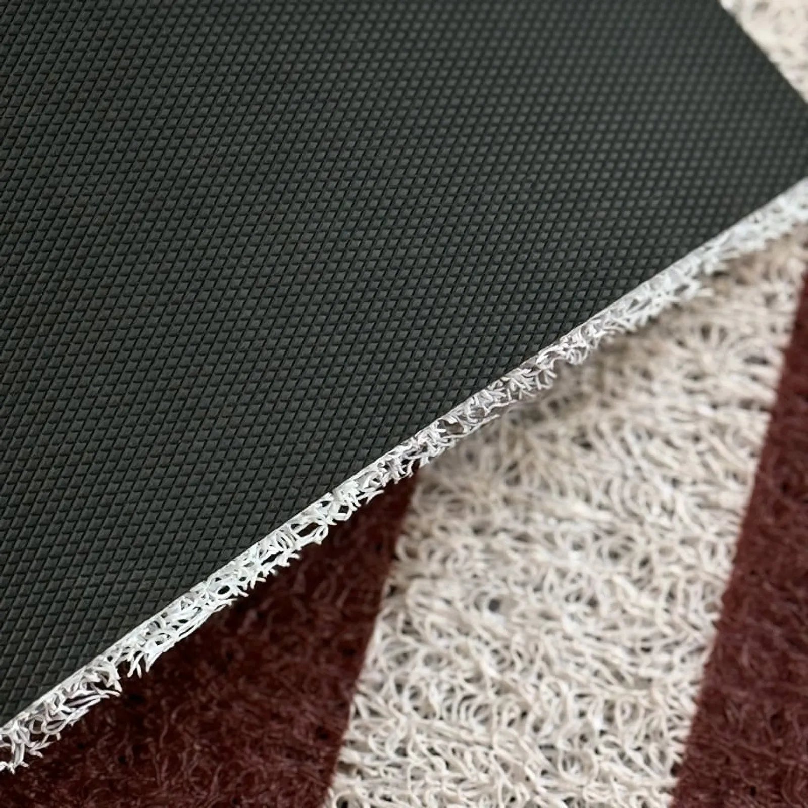 Close up detail of black non-slip backing and PVC coil thickness - RoomDen