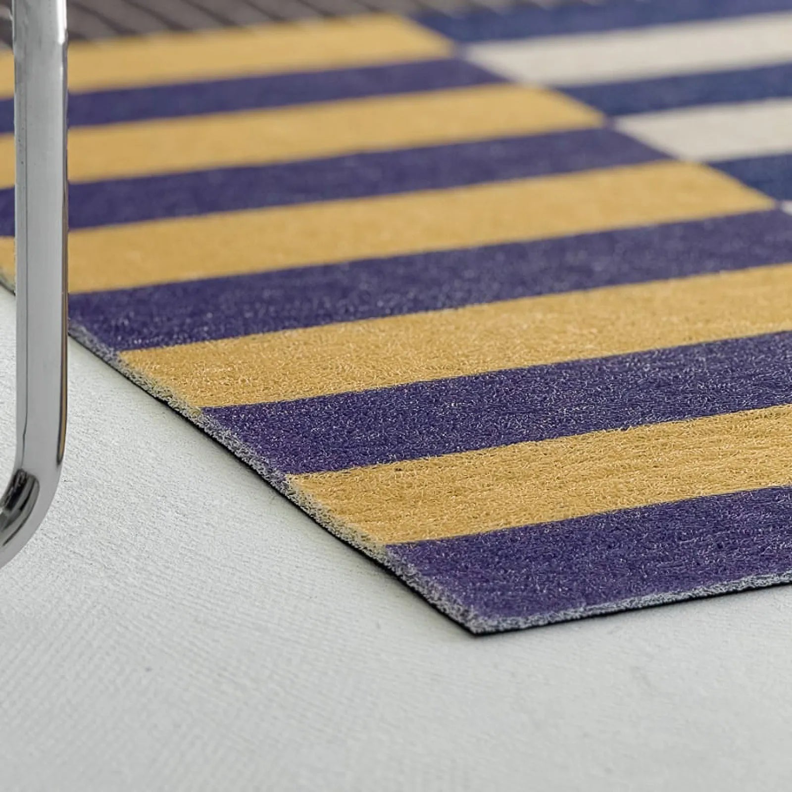 Detail shot of yellow and purple stripe coil mat texture - RoomDen