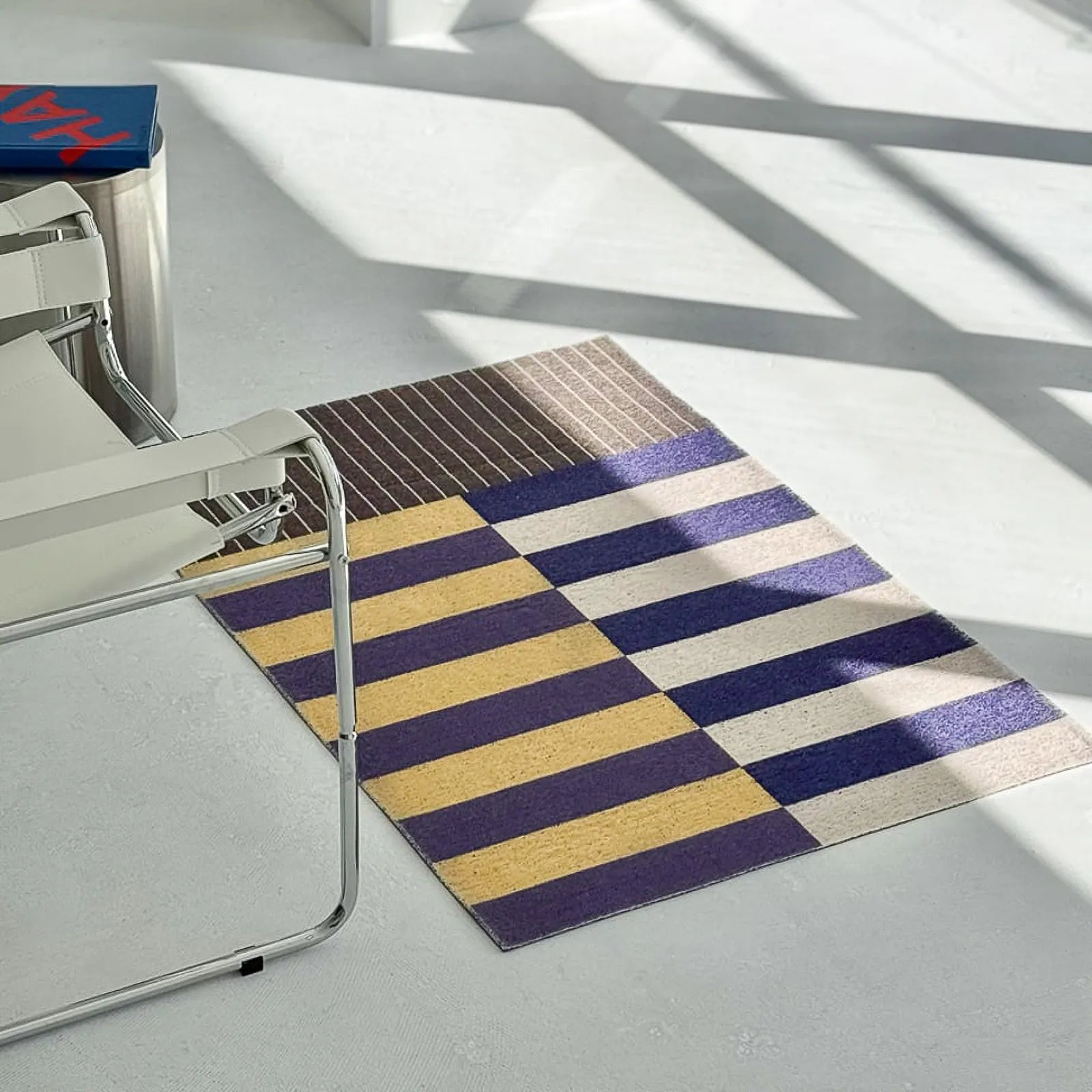 Angled view of custom cut Bauhaus PVC mat on concrete floor - RoomDen