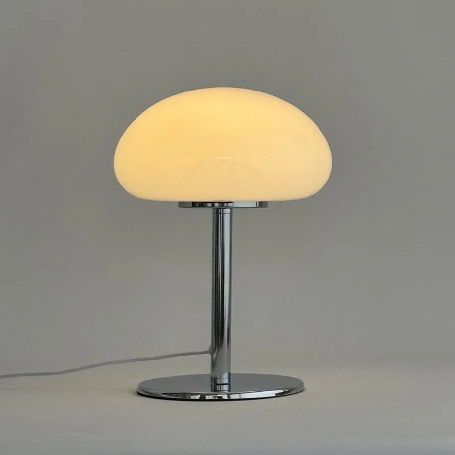 Studio shot of the white mushroom accent lamp glowing with a warm light - RoomDen.