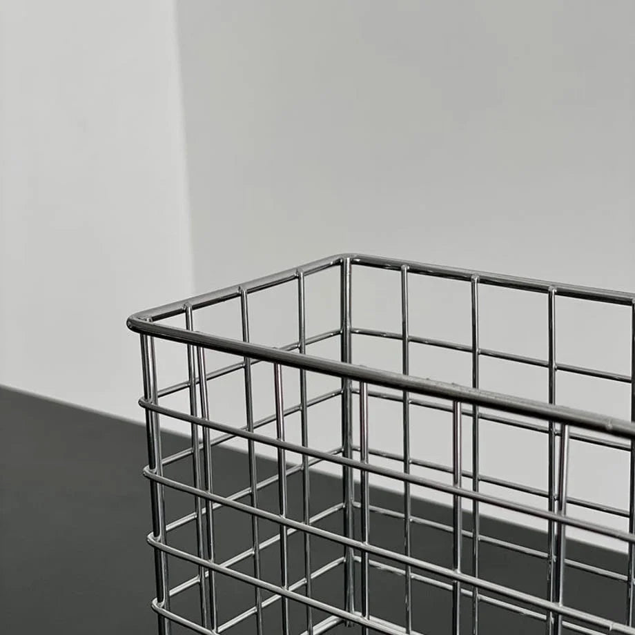 Corner detail of the sleek metal wireframe of the desktop organizer basket. - RoomDen