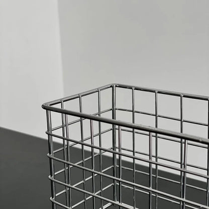 Corner detail of the sleek metal wireframe of the desktop organizer basket. - RoomDen
