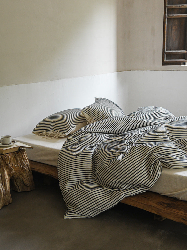 Ashfield Black Pinstripe Bedding Set – Angled view of black striped duvet and pale reverse - Roomden