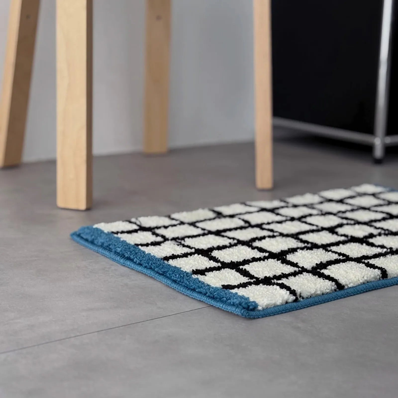 Low angle view highlighting the shaggy texture and blue hem of the accent rug - RoomDen