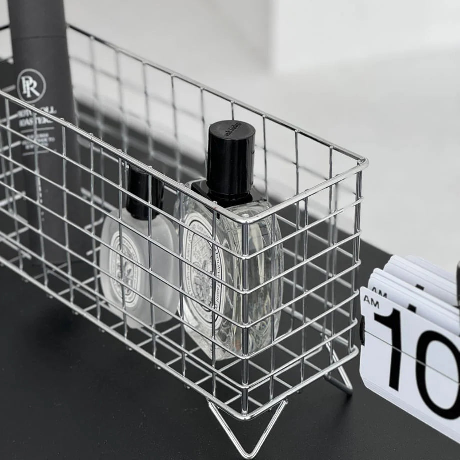 Detailed shot of the metal grid construction of the desktop organizer next to a clock. - RoomDen
