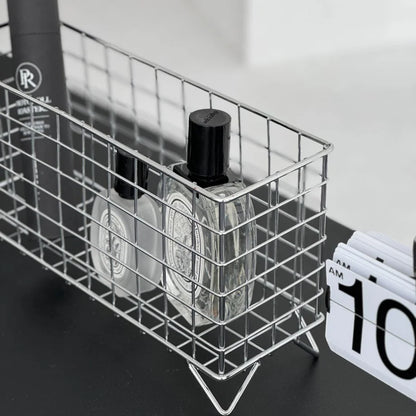 Detailed shot of the metal grid construction of the desktop organizer next to a clock. - RoomDen