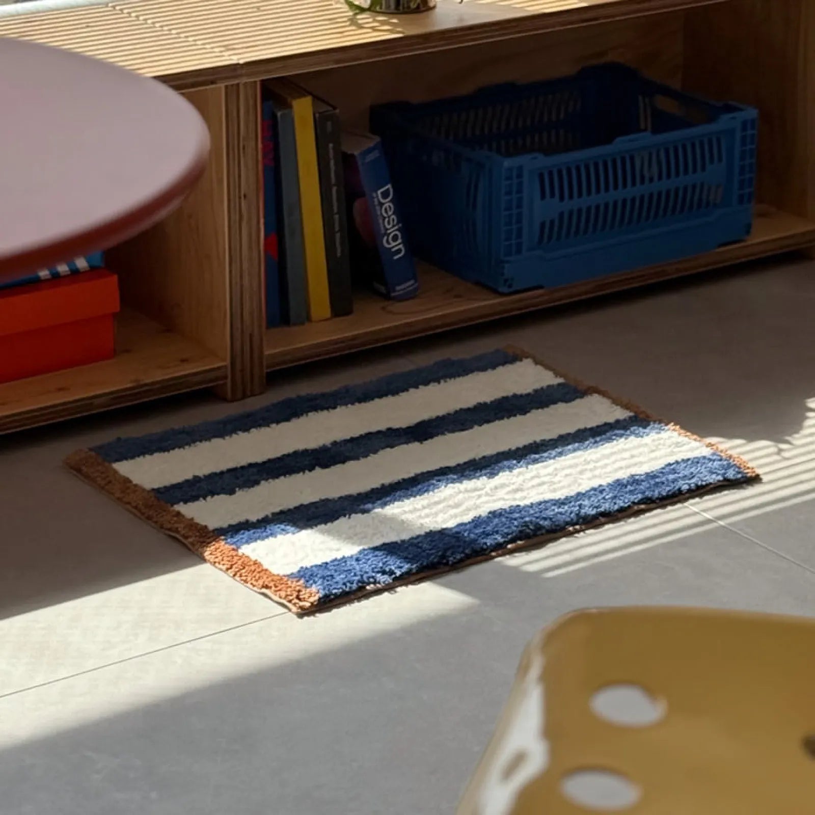 Side angle view of blue striped rug highlighting soft texture - RoomDen