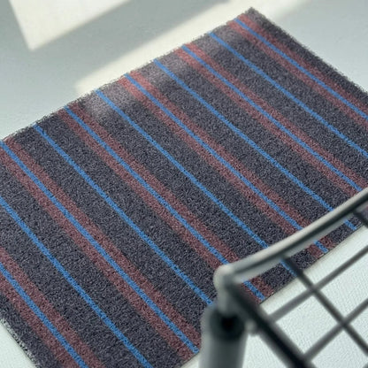 High angle detail of Dark Grey PVC Coil Rug showing texture and stripe pattern