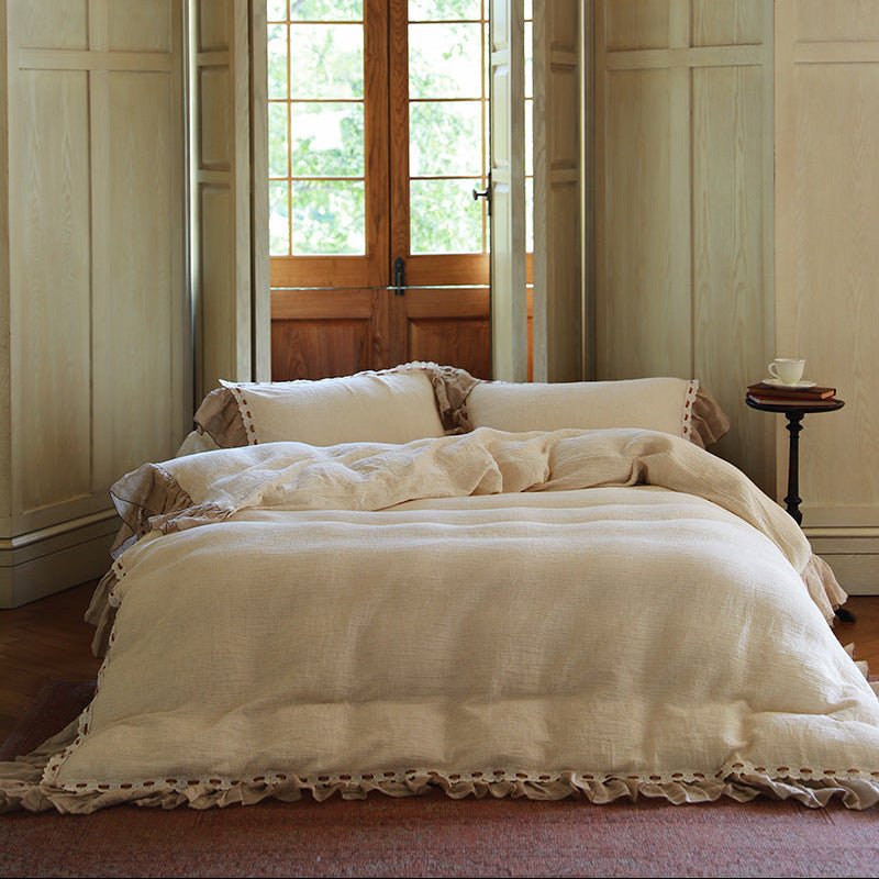 Elderfield Ruffle Lace Cotton-Linen Bedding Set – front view of cream bedding framed by a tall window - Roomden