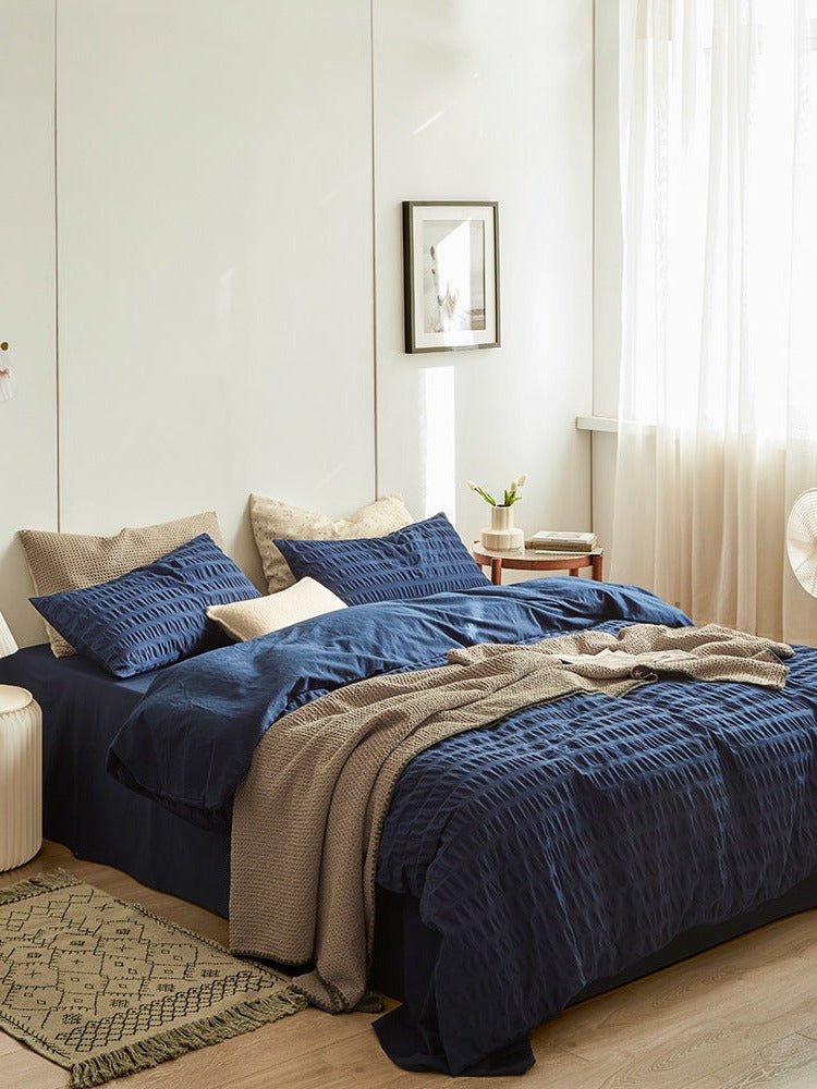 Marlon Seersucker Cotton Bedding Set – navy bedding viewed from the side in window light - Roomden