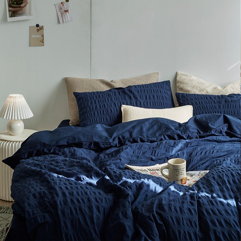 Marlon Seersucker Cotton Bedding Set – navy duvet spread below matching textured pillows - Roomden