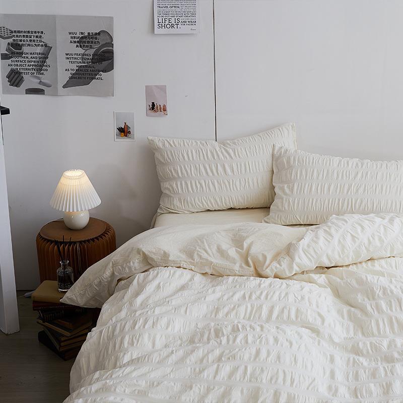 Marlon Seersucker Cotton Bedding Set – ivory seersucker duvet beneath matching pillows and wall prints - Roomden