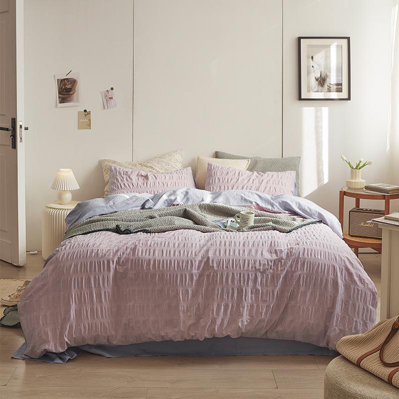 Marlon Seersucker Cotton Bedding Set – full lilac-pink textured bed beneath framed artwork - Roomden