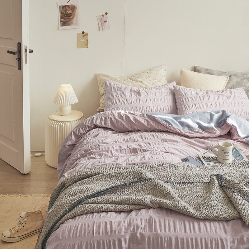 Marlon Seersucker Cotton Bedding Set – lilac-pink bedding viewed from the side beside an open door - Roomden