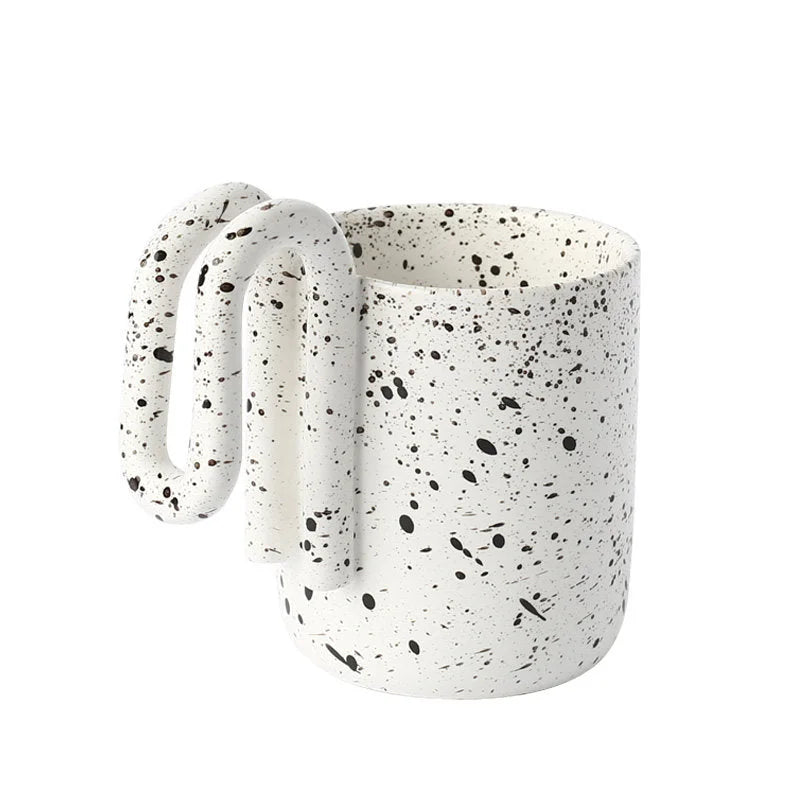 Black Splatter ceramic mug with sculptural loop handle on a white background - RoomDen