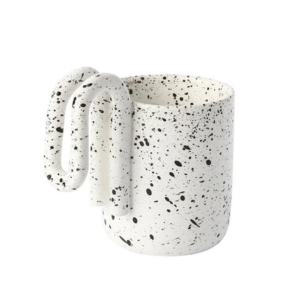 Black Splatter ceramic mug with sculptural loop handle on a white background - RoomDen
