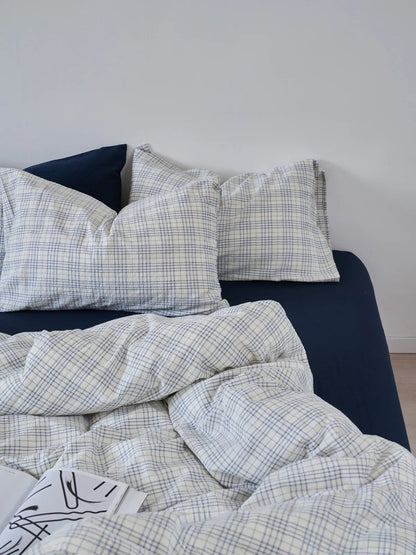 Full view of the Navy Plaid Washed Cotton Bedding Set on a bed against a clean white wall - RoomDen