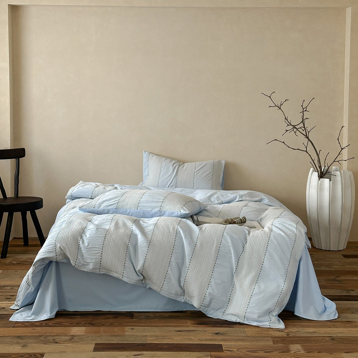 Solmere Striped Waffle-Weave Cotton Bedding Set – sky blue stripe full bed arranged beside a tall vase - Roomden