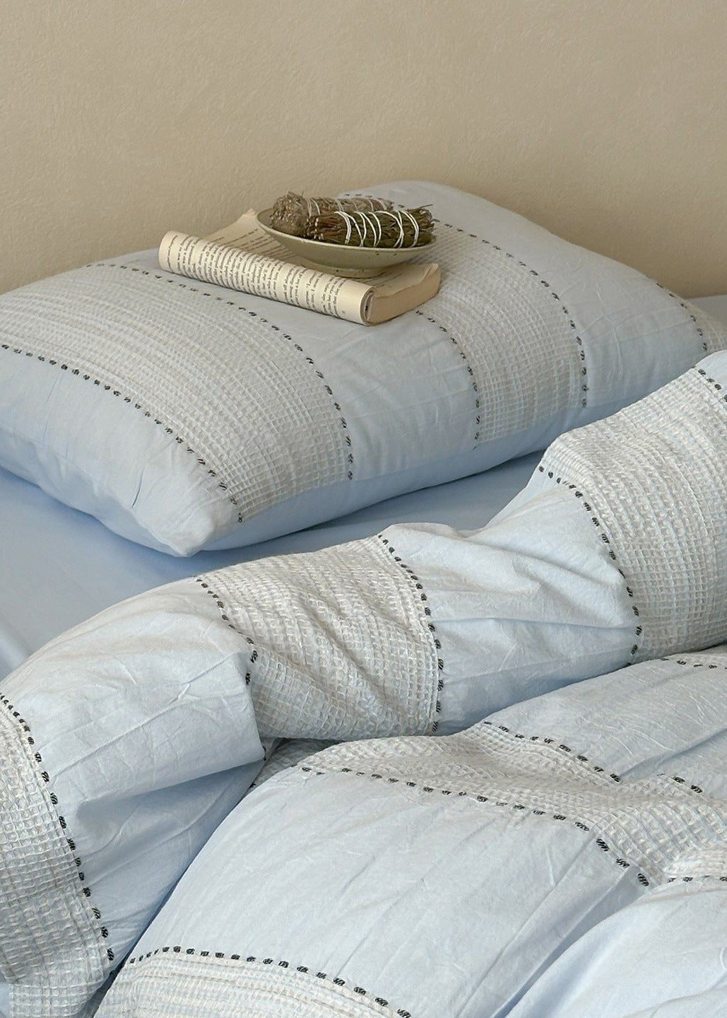 Solmere Striped Waffle-Weave Cotton Bedding Set – sky blue stripe striped pillow resting on the textured duvet - Roomden