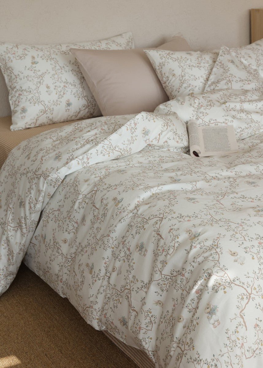 Verbena Botanical Cotton Bedding Set – rabbit and branch print duvet folded across the bed - Roomden