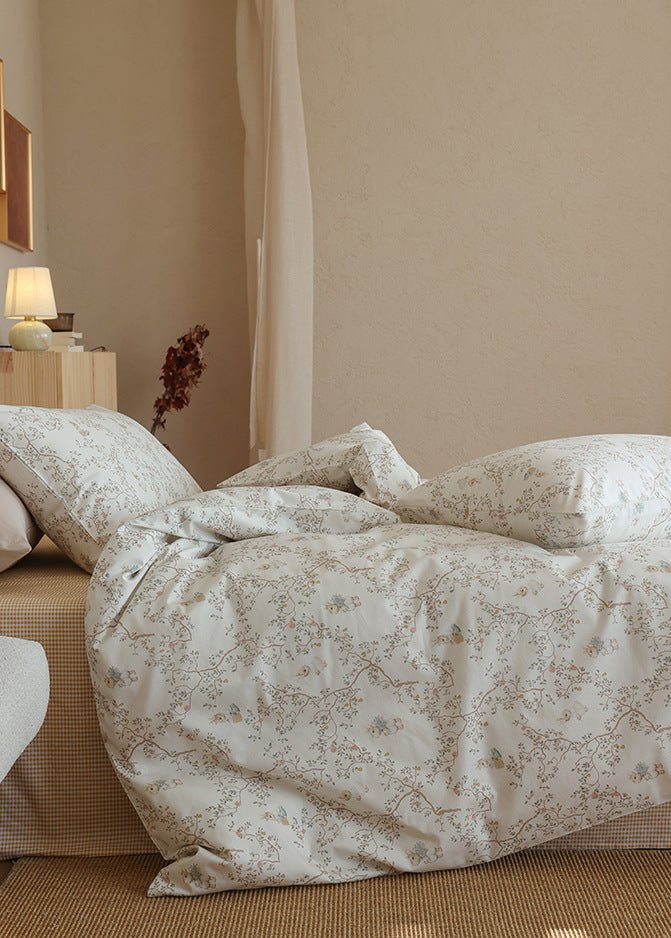 Verbena Botanical Cotton Bedding Set – side view of ivory printed bedding falling over the bed edge - Roomden