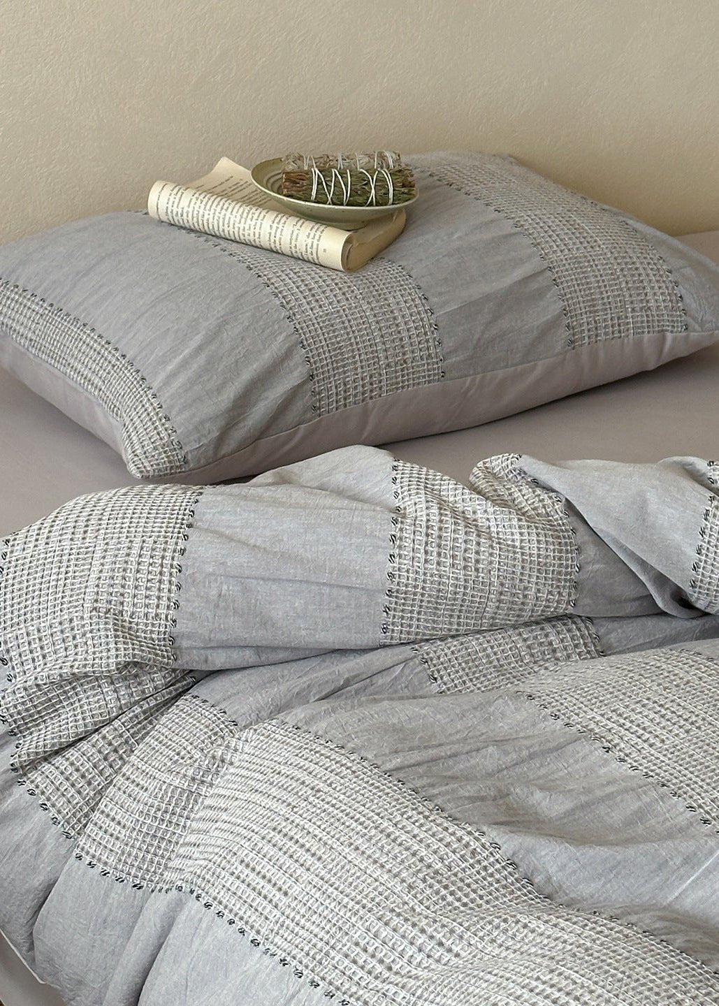 Solmere Striped Waffle-Weave Cotton Bedding Set – fog grey stripe striped pillow resting on the textured duvet - Roomden