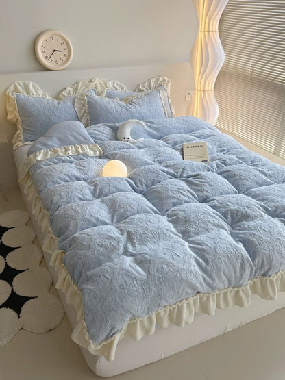 Full view of pastel blue bow embossed bedding set with cream ruffled edges - RoomDen