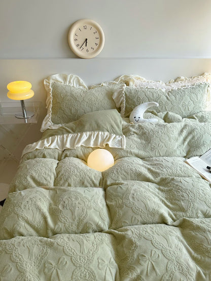 Romantic light green flannel bedding with cream ruffled pillowcases and warm light - RoomDen