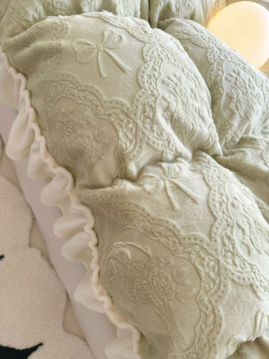 Close-up of light green flannel fleece fabric showing embossed bow design - RoomDen