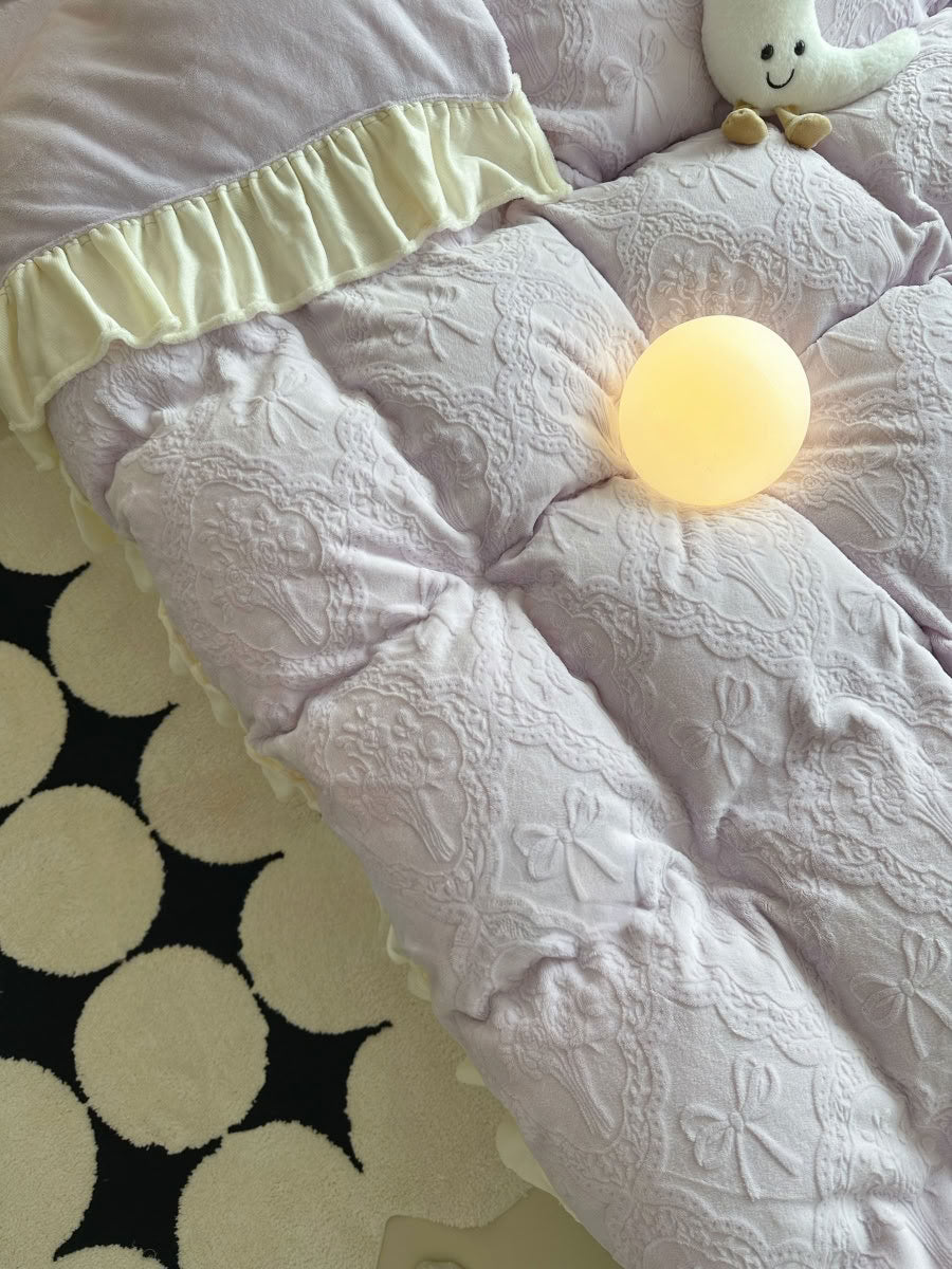 Close-up of light purple flannel fabric showing embossed bow and lace details - RoomDen