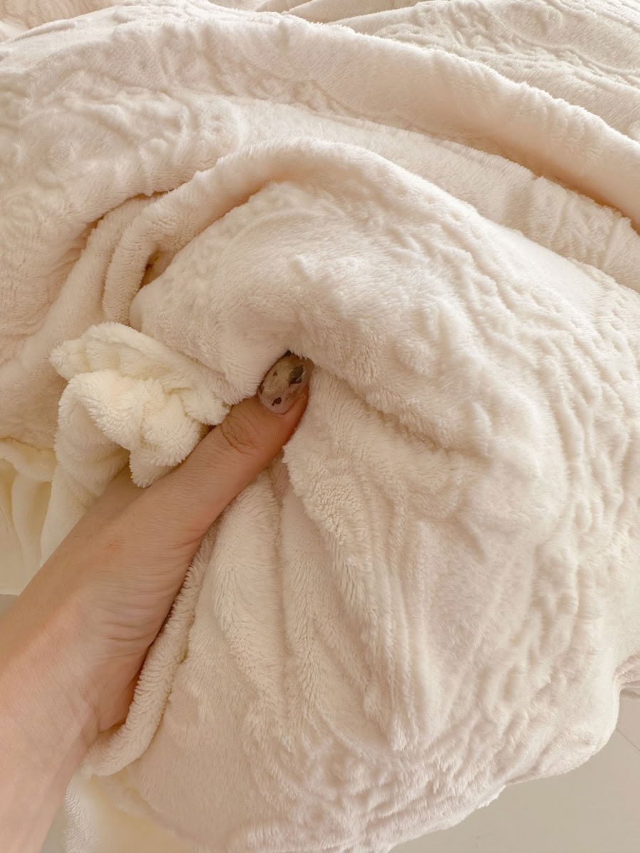 Close-up of plush flannel fleece fabric showing embossed bow and floral texture - RoomDen