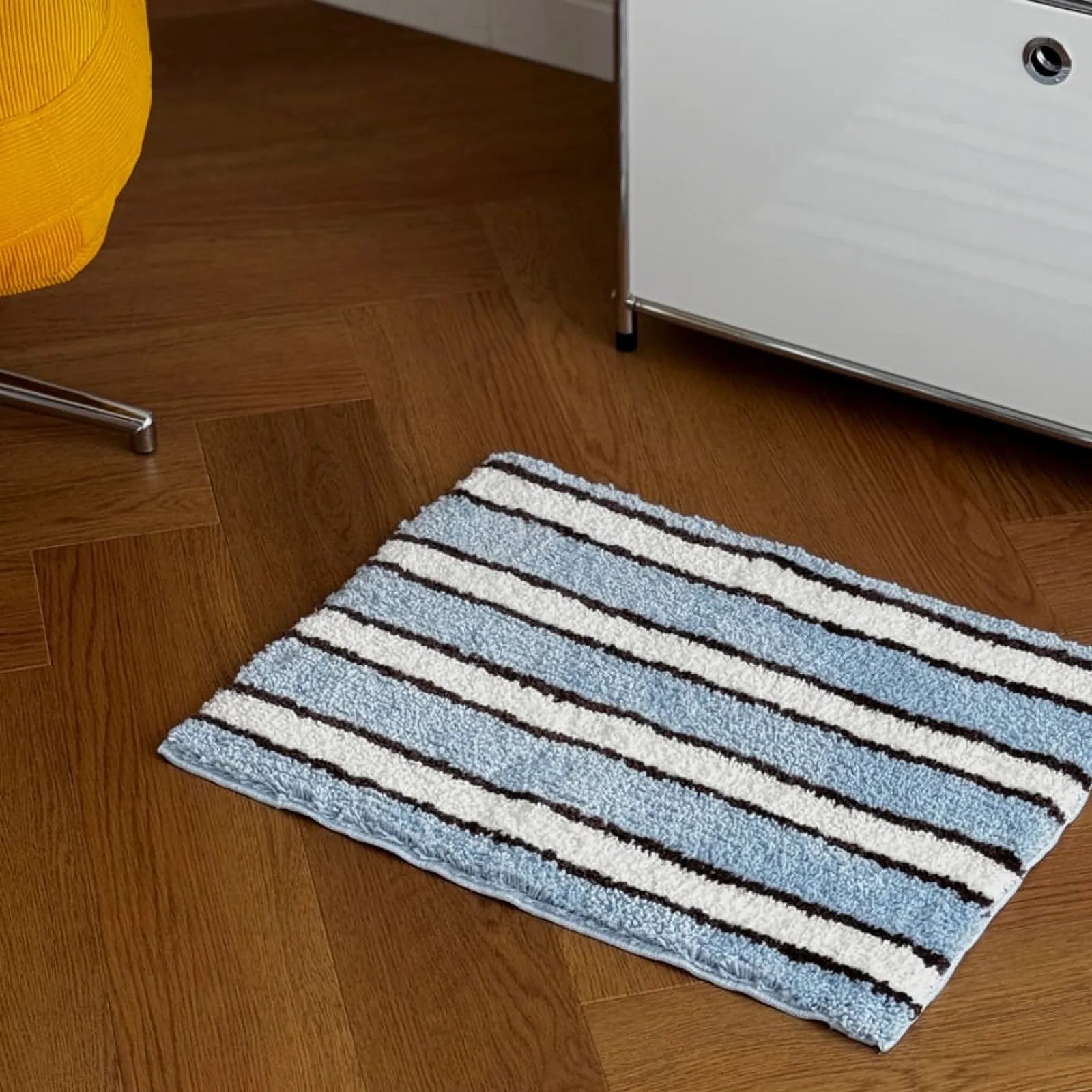 High-angle view of breezy coastal striped rug on wooden flooring - RoomDen