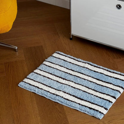 High-angle view of breezy coastal striped rug on wooden flooring - RoomDen