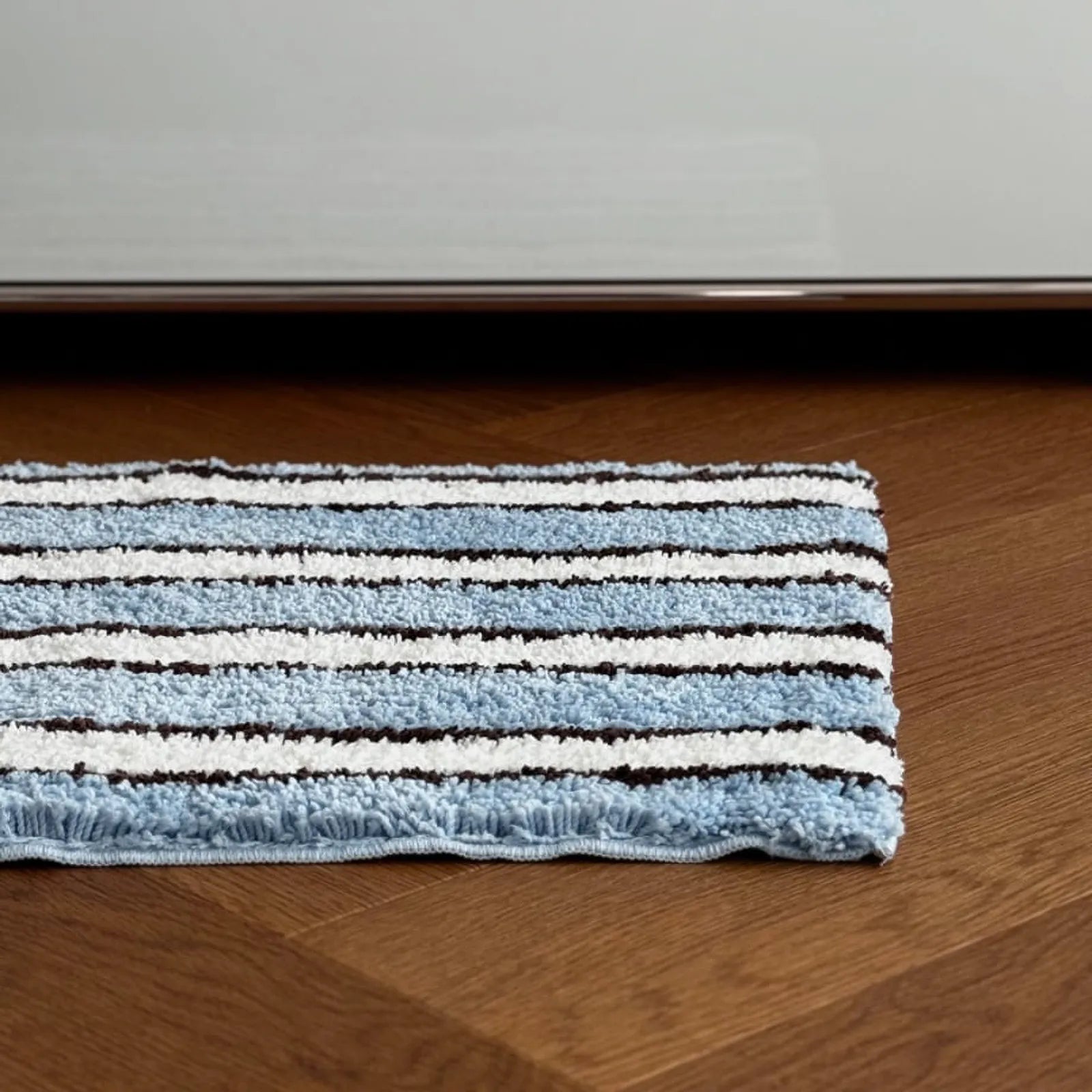 Top-down view showing the texture of blue white and brown stripes - RoomDen