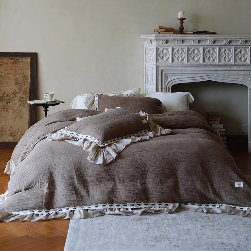 Elderfield Ruffle Lace Cotton-Linen Bedding Set – front angle of the cocoa duvet beside a decorative fireplace - Roomden