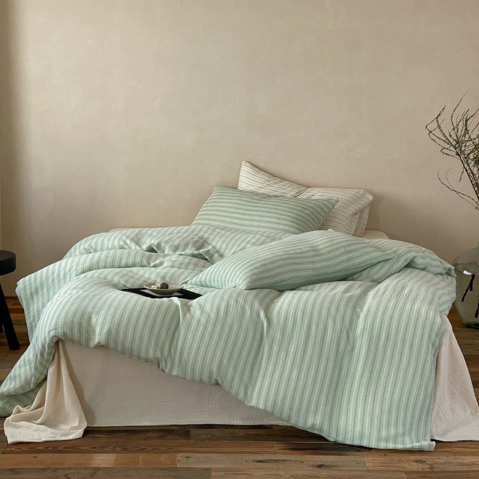 Halden Striped Cotton Double Gauze Bedding Set – sage green striped duvet draped across the bed - Roomden