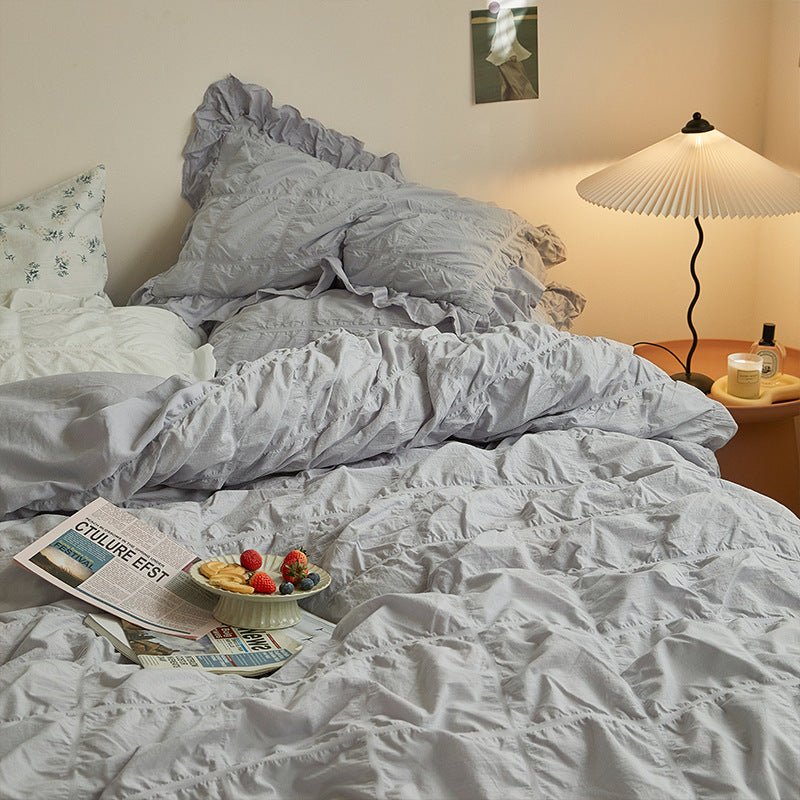 Odessa Ruffled Cotton Blend Bedding Set – silver-blue gathered duvet folded below matching pillows - Roomden