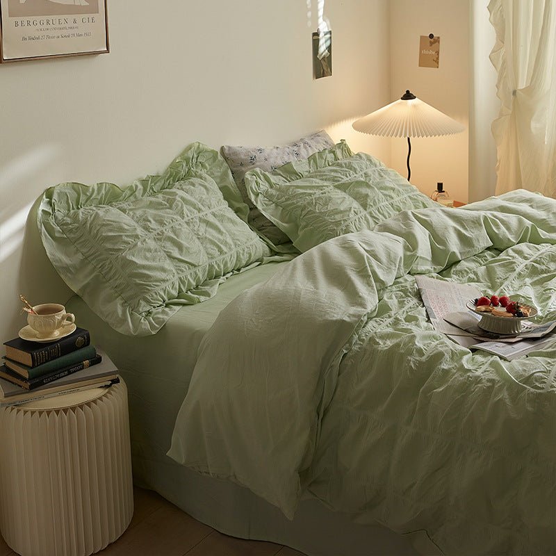 Odessa Ruffled Cotton Blend Bedding Set – mint-green duvet turned back beside a round bedside table - Roomden