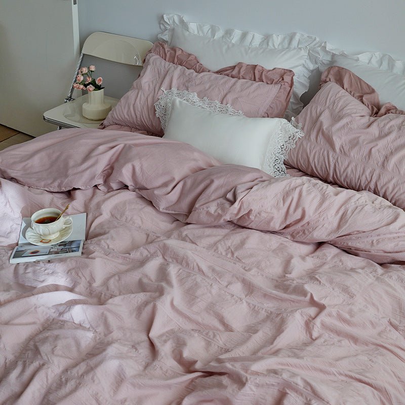 Odessa Ruffled Cotton Blend Bedding Set – pink duvet turned back beneath matching ruffled pillows - Roomden