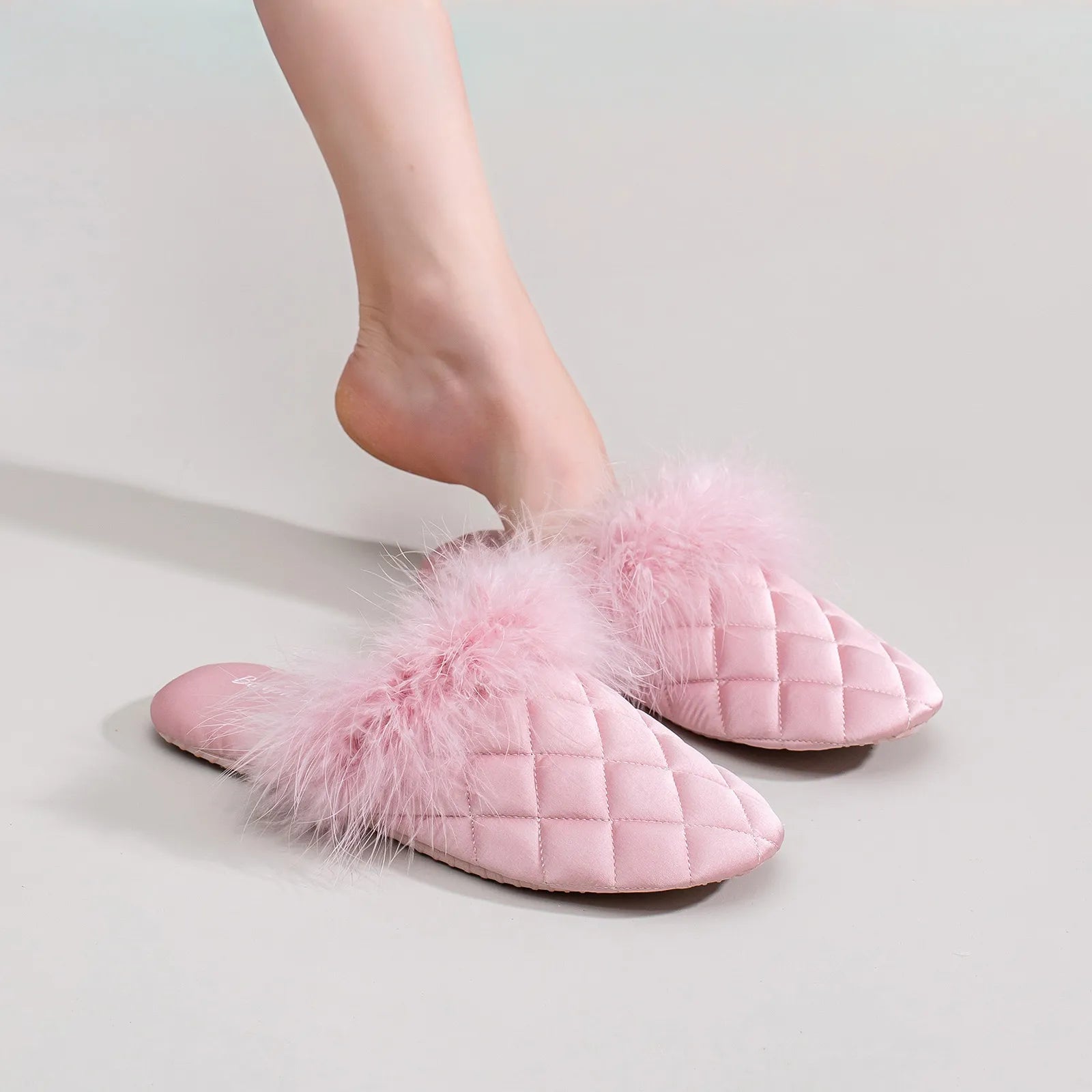 Baby pink feathery satin house slippers styled on legs - RoomDen