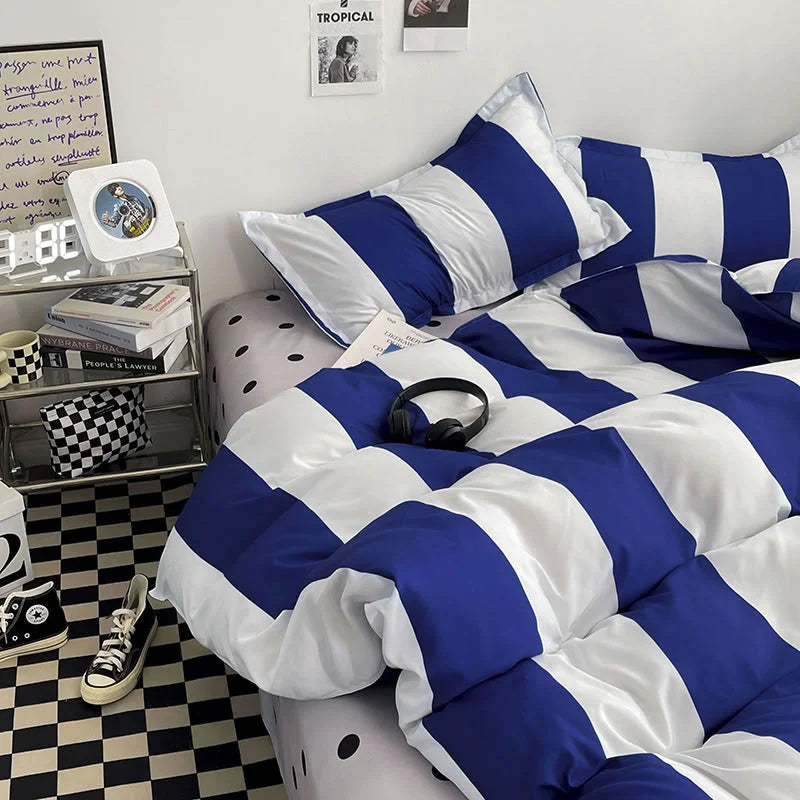 Detailed shot of the corner of the bed with the Blue & White Striped Bedding Set, showing the contrast and pattern - RoomDen